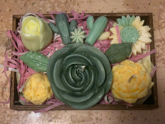 Decorative set of flower candles and wax melts in a wooden box.